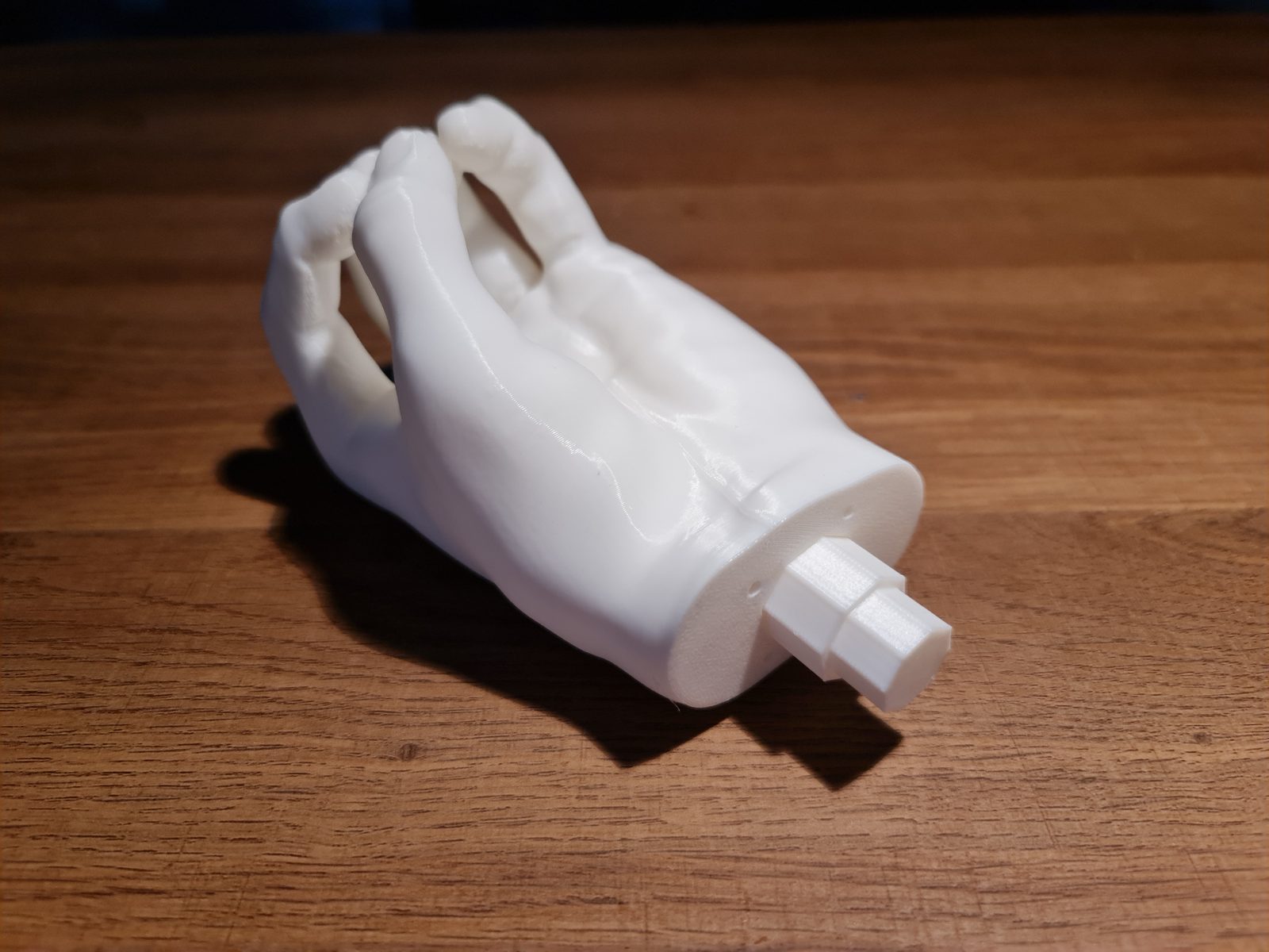 A printed hand lying on its side, with the octagonal peg sticking out of the wrist
