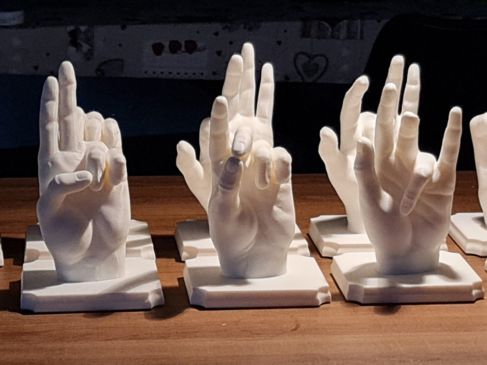 A row of 3D-printed hands on their bases
