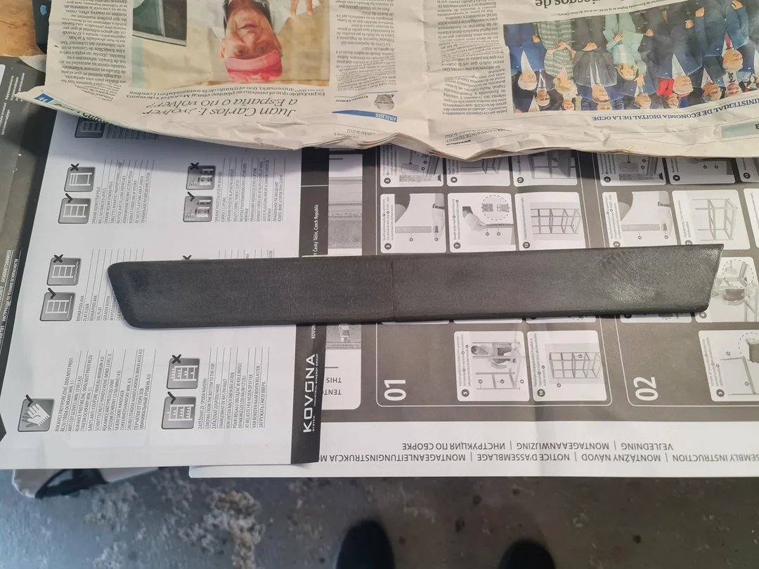 Door trim after filling and sanding, lying on newspaper