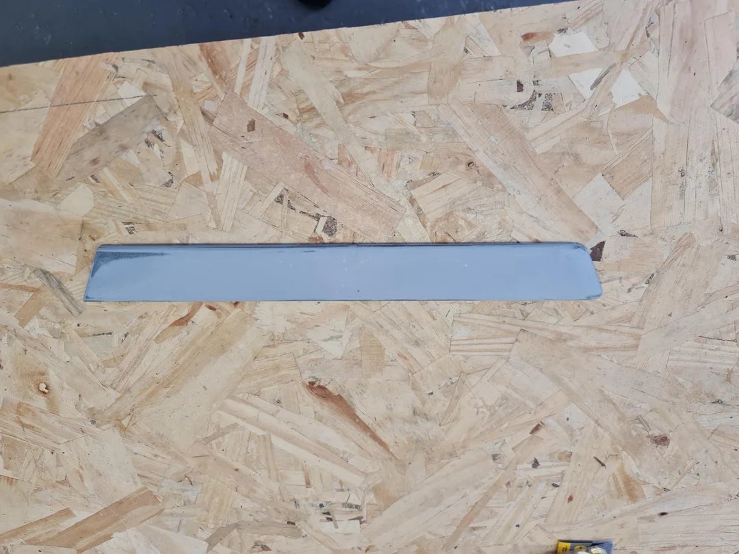 Printed door trim part lying on a workbench