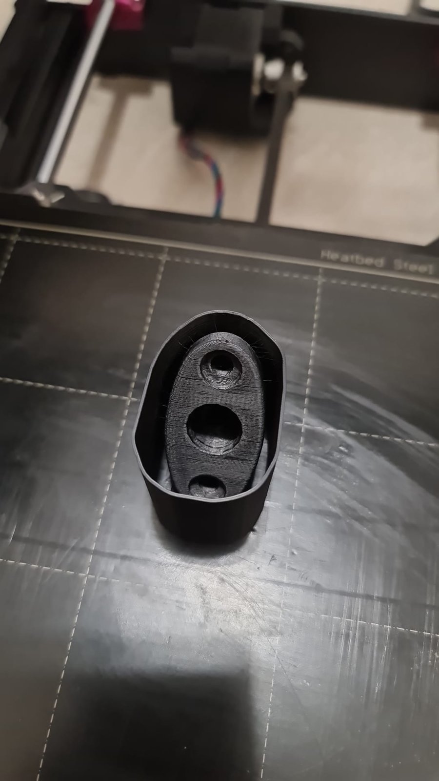 Black sun visor bracket on the print bed