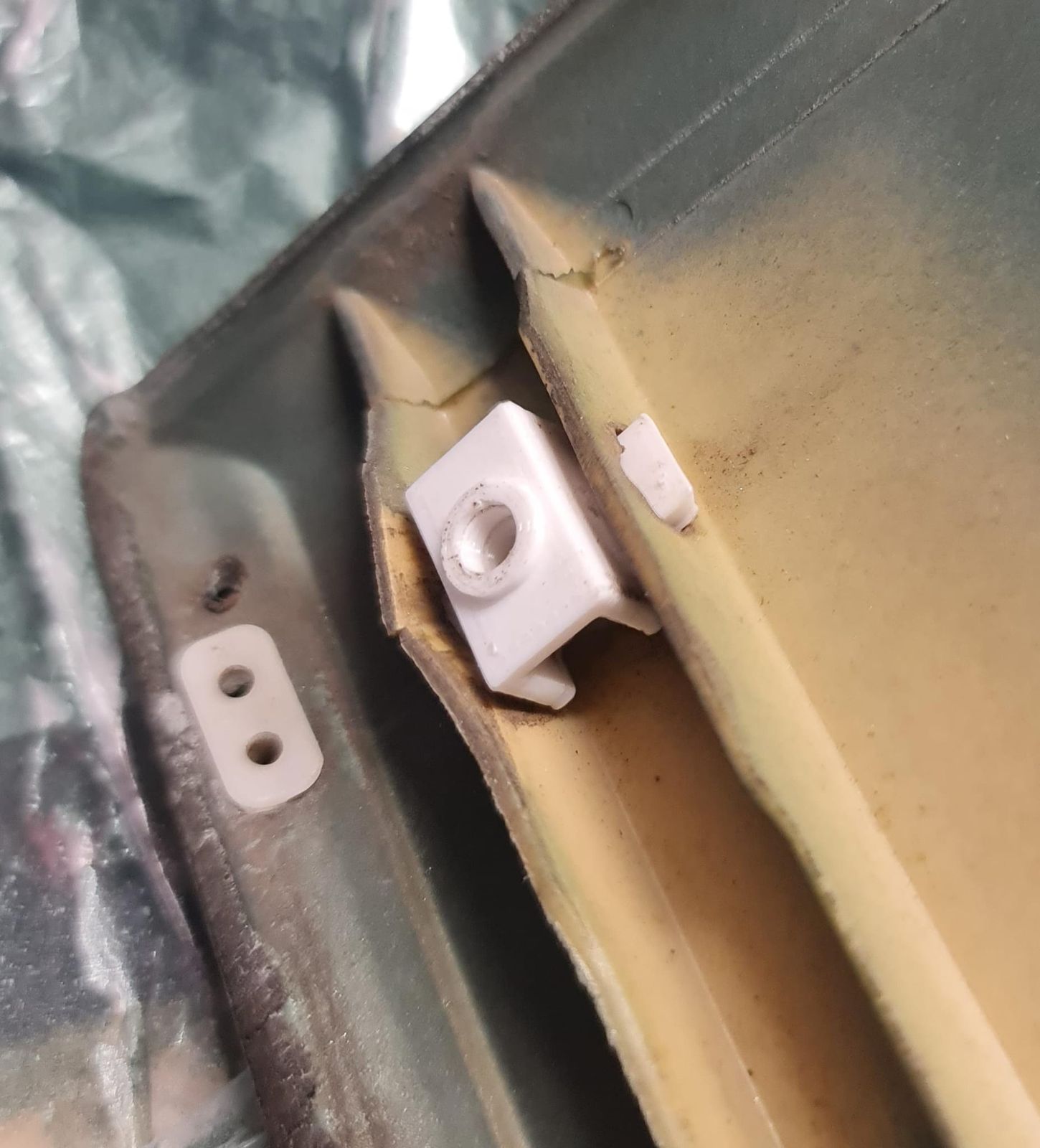 White 3D-printed trim mounting pin fitted in the door panel