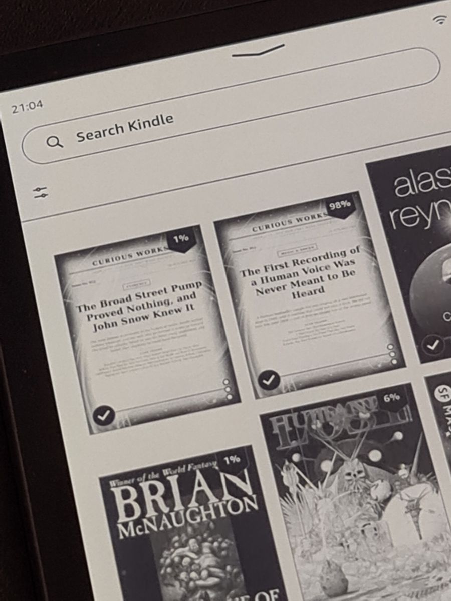The Kindle library with the Curious Works issues 011 and 012 shown as covers next to ordinary books